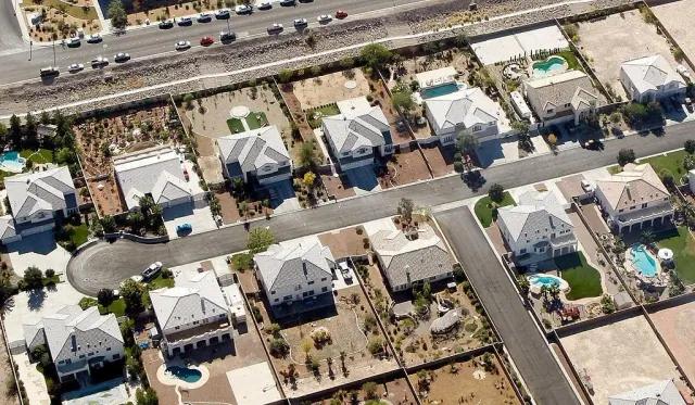 Aerial view of houses, roads and backyard swimming pools