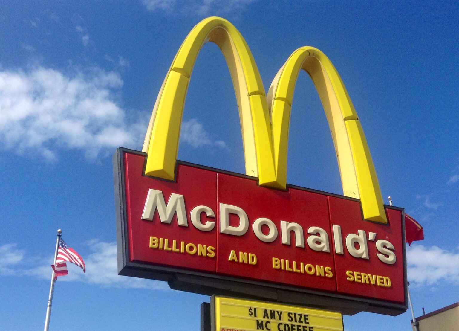 McDonalds golden arches against a blue sky.