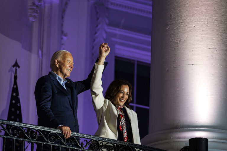 WASHINGTON, DC - JULY 04: President Joe Biden and Vice President Kamala Harris join hands in the air after watching the fireworks on the National Mall with First Lady Jill Biden and Second Gentleman Doug Emhoff from the White House balcony during a 4th of July event on the South Lawn of the White House on July 4, 2024 in Washington, DC. The President is hosting the Independence Day event for members of the military and their families. (Photo by Samuel Corum/Getty Images)