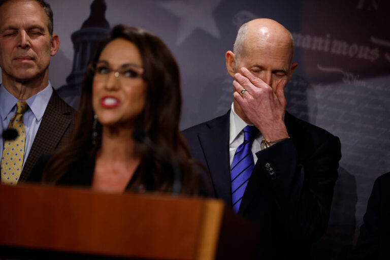 WASHINGTON, DC - MARCH 22: Sen. Sen. Rick Scott (R-FL) (R) listens to House Freedom Caucus member Rep. Lauren Boebert (R-CO) talk to reporters about the federal debt limit during a news conference caucus Chair Rep. Scott Perry (R-PA) (L) at the U.S. Capitol on March 22, 2023 in Washington, DC. The conservative Republicans were critical of President Joe Biden's federal budget proposal and repeated their slogan, "shrink Washington and grow America," while demanding that spending cuts go hand-in-hand with raising the debt limit