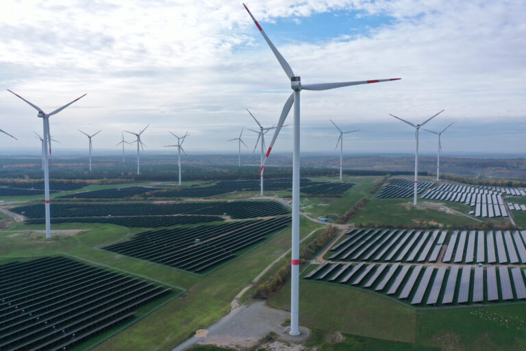 KLETTWITZ, GERMANY - NOVEMBER 01: In this aerial view, wind turbines producing electricity spin over a solar park on November 01, 2022 near Klettwitz, Germany. The German government is seeking an accelerated transition to renewable energy sources in order to both meet its climate goals and to reduce its import needs of fossil fuels.