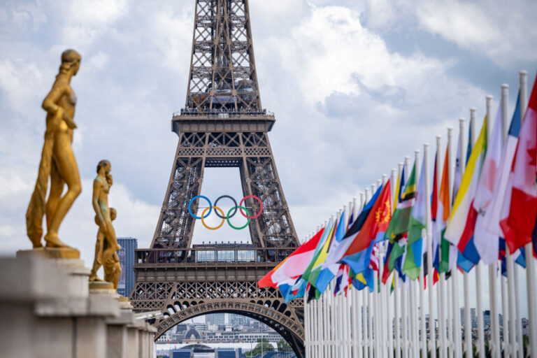 PARIS, FRANCE - JULY 21: A general view of the Eiffel Tower with the Olympics rings pictured with national flags of competing countries from the Place du Trocadero ahead of Paris 2024 Olympic Games on July 21, 2024 in Paris, France. rumors of a bed bug infestation plagued the city