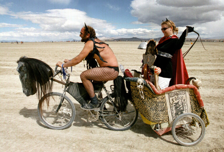 377801 10: A dominating woman gets a chariot ride across the playa during the15th annual Burning Man festival September 2, 2000 in the Black Rock Desert near Gerlach, Nevada. Despite high winds, dust storms, and a bit of rain, some 27,000 people camped out on a remote desert playa, or dry lake, for the week-long counter-cultural celebration of art and "radical self-expression." This year's theme was the body.