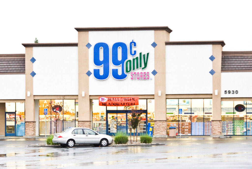 Image of a storefront of store 99 Cents only with a car in the parking lot out front. 