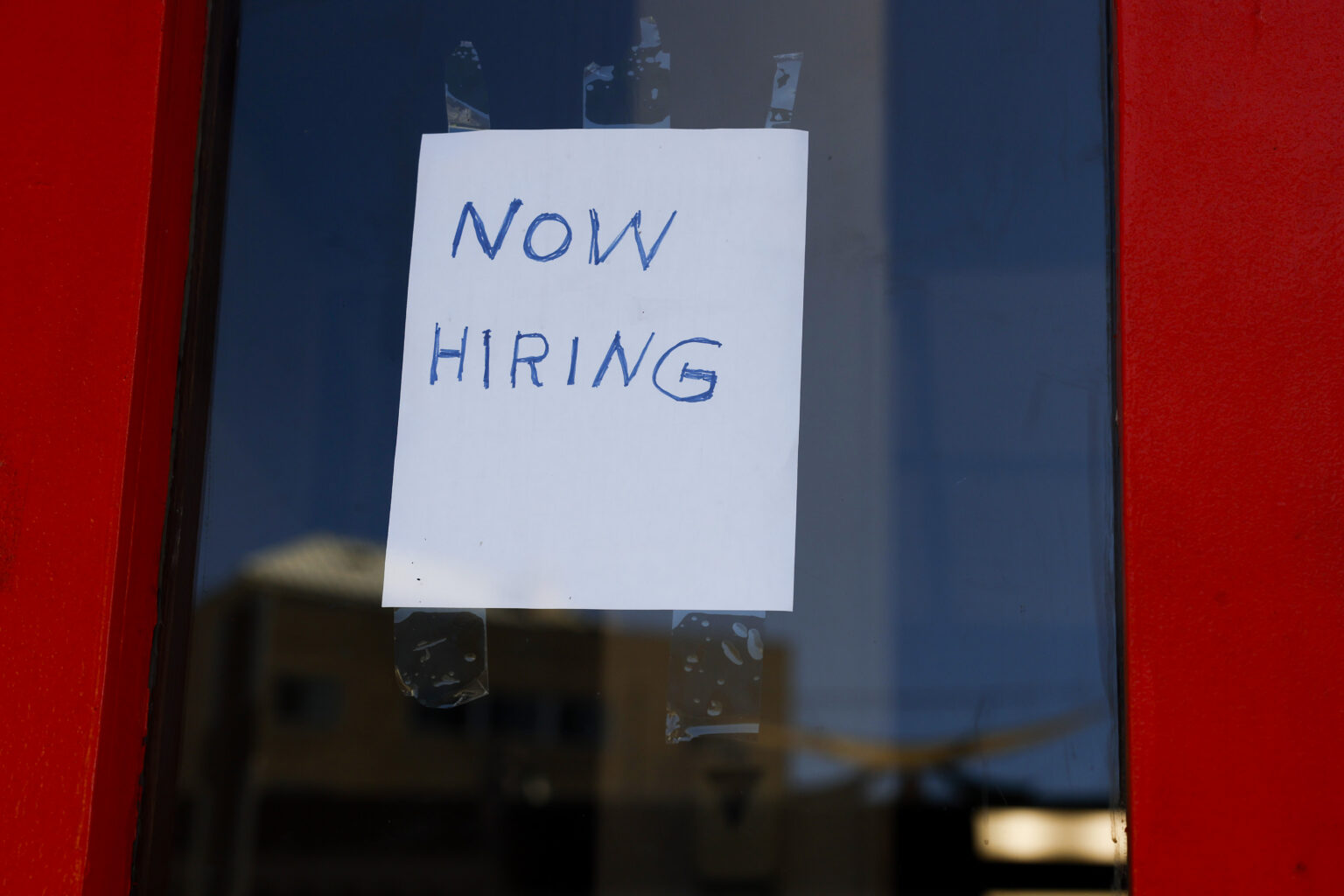 now highing sign taped to a window