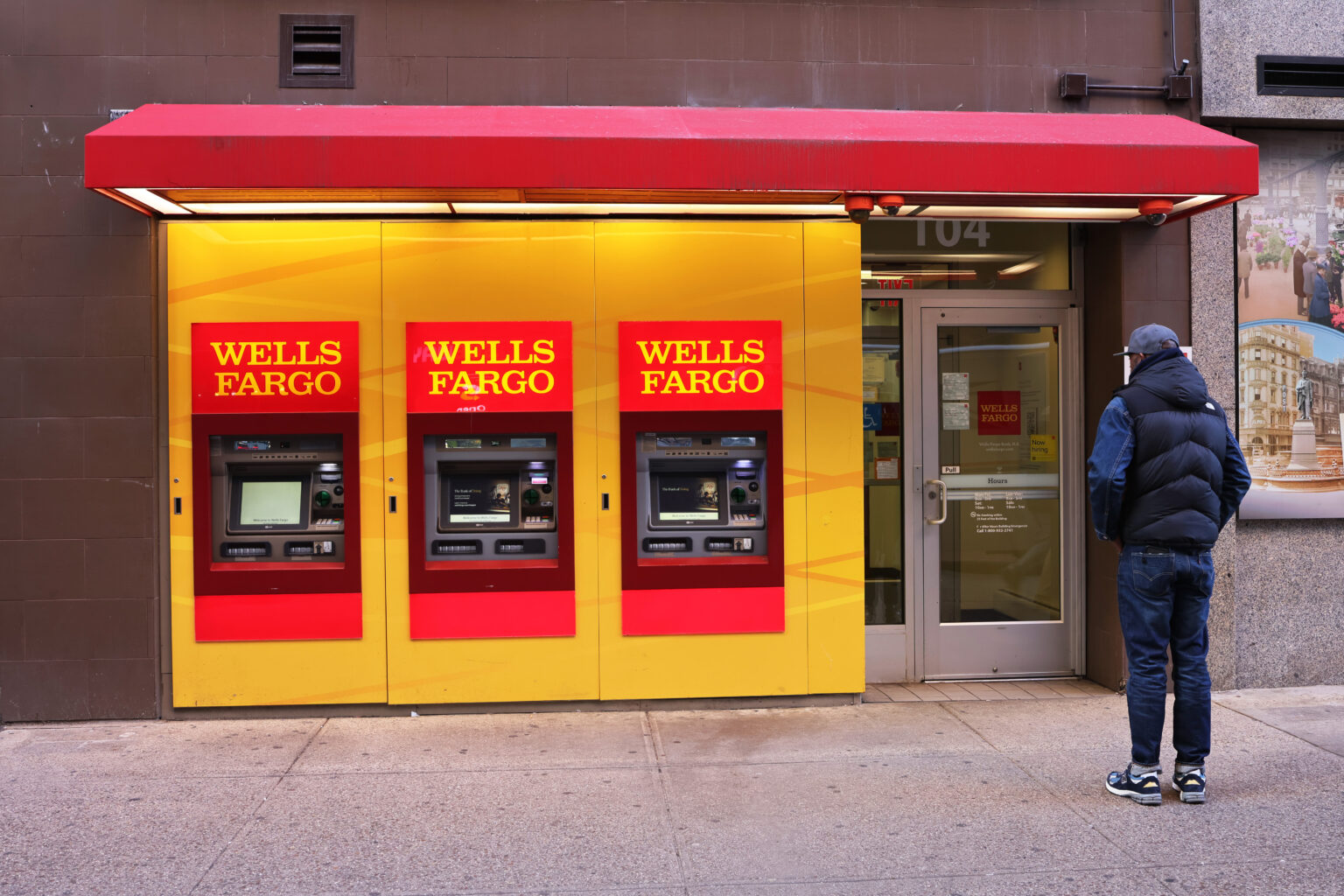 NEW YORK, NEW YORK - DECEMBER 20: People walk past a Wells Fargo bank on 14th Street on December 20, 2022 in New York City. Wells Fargo has agreed to pay $3.7 billion to settle charges that the bank harmed its customers by charging illegal fees and interest on auto loans and mortgages and incorrectly applied overdraft fees against savings and checking accounts. The Consumer Financial Protection Bureau ordered the bank to repay $2 billion to consumers and also enacted a $1.7 billion penalty for overdraft protection abuse.