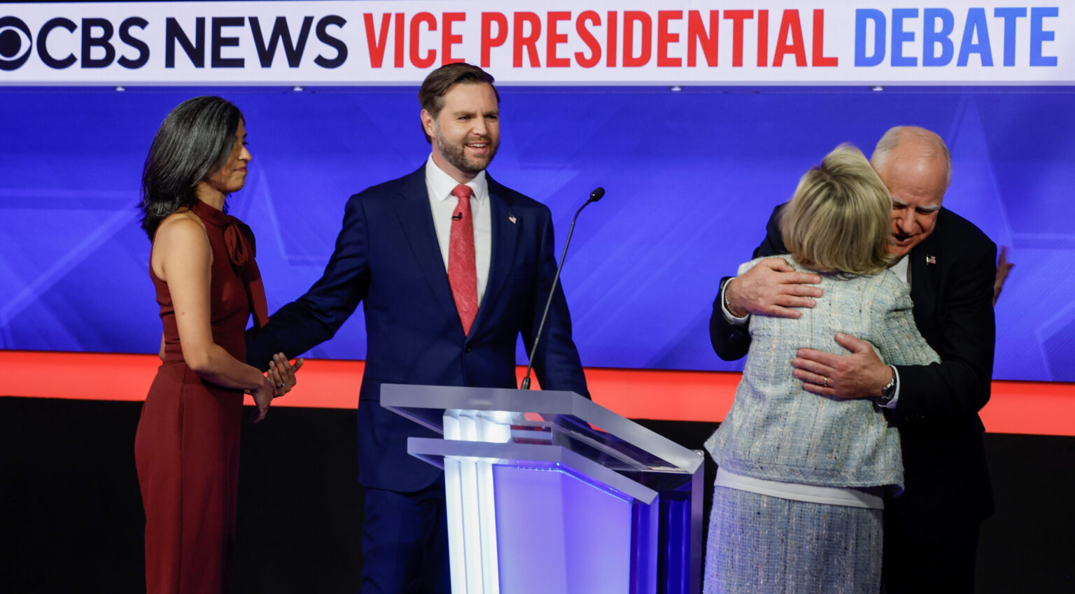 NEW YORK - OCTOBER 01: Democratic vice presidential candidate Minnesota Gov. Tim Walz and his wife Gwen Walz (R) embrace as Republican vice presidential candidate Sen. JD Vance (R-OH) and his wife Usha Vance look on after a debate at the CBS Broadcast Center on October 1, 2024 in New York City. This is expected to be the only vice presidential debate of the 2024 general election.