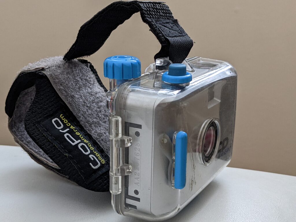 gopro camera on a table with a headstrap.