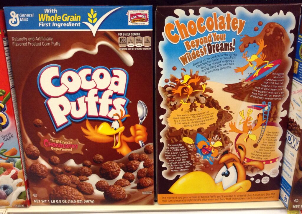 boxes of breakfest cereal cocoa puffs on a grocery store shelf