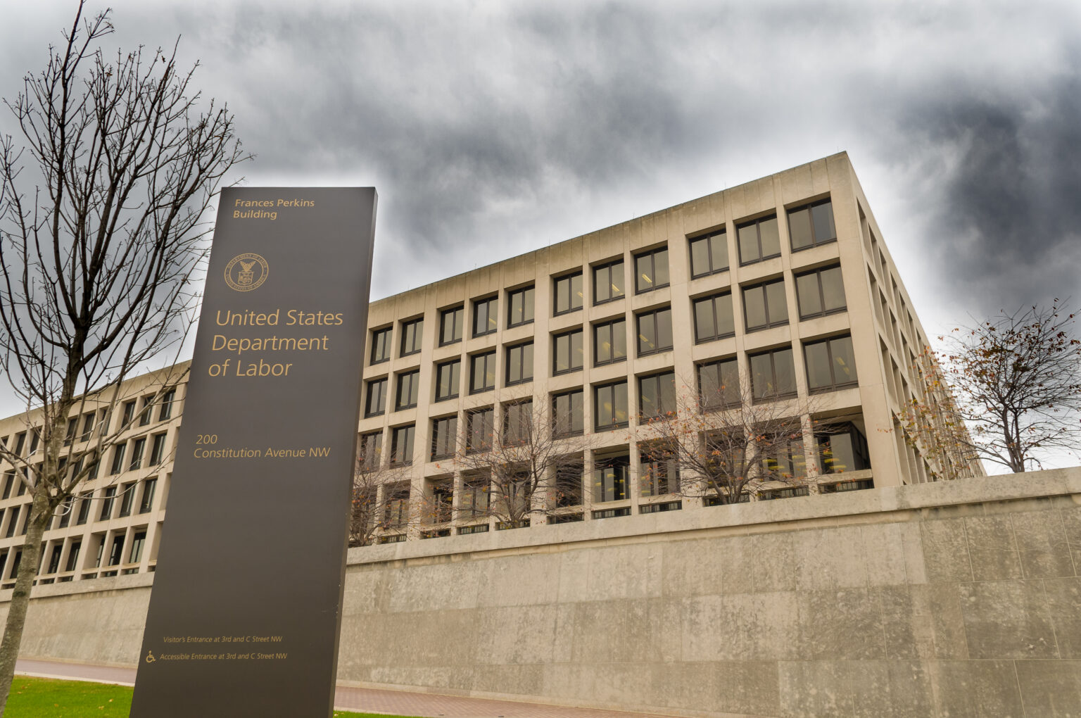 Exterior of Department of Labor Building against a grey cloudy sky