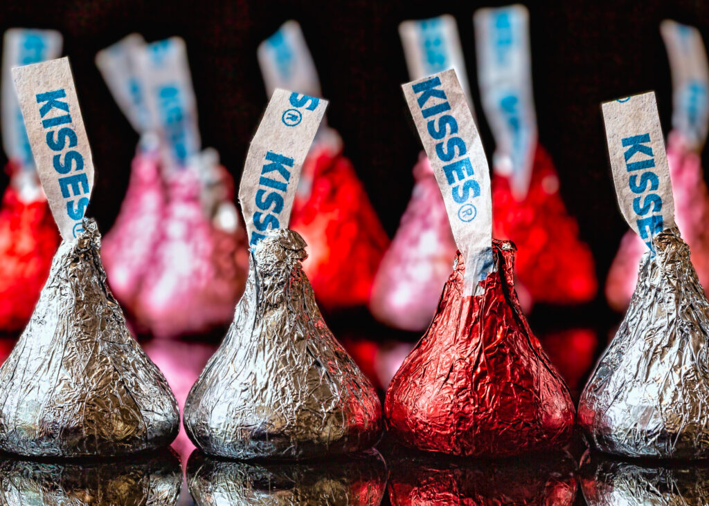 a few hershey kisses lined up against a black background