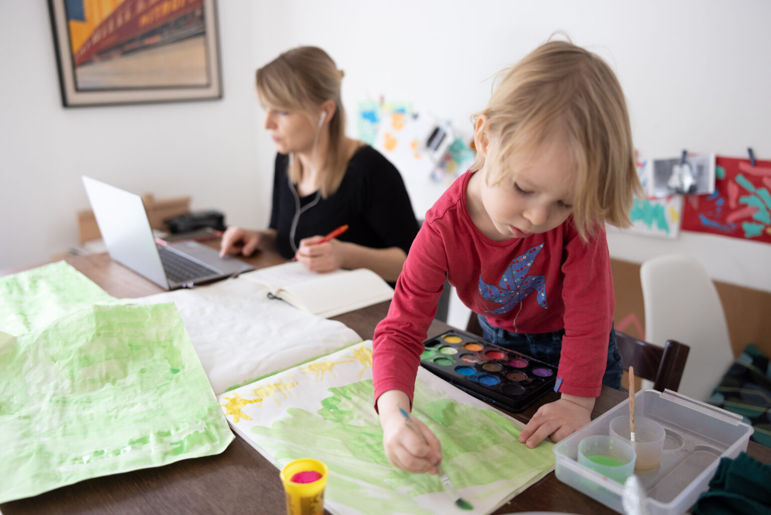 BERLIN, GERMANY - FEBRUARY 18: The photographer's son paints while his mother works and attends a digital conference at home in Zehlendorf district during the second wave of the coronavirus pandemic on February 18, 2021 in Berlin, Germany. The hard lockdown state governments launched in December, in which non-essential shops were closed and people's movements restricted in high-risk areas, has been continued into February. Some state authorities have indicated some easing might be possible soon as COVID-19 infection and death rates continue to fall. Meanwhile the vaccination rollout remains hampered by a shortage of vaccines.