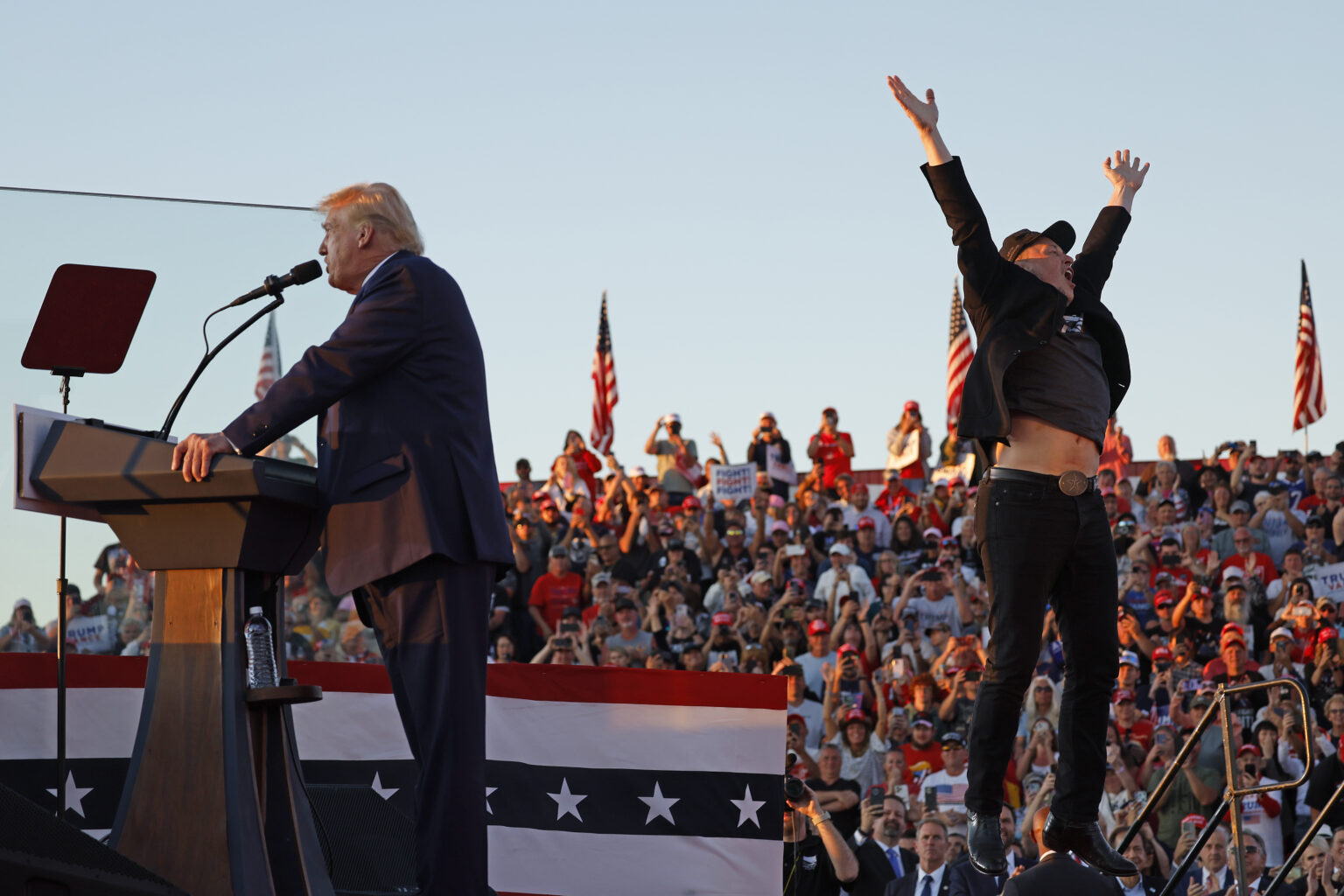 BUTLER, PENNSYLVANIA - OCTOBER 05: Elon Musk leaps on stage with Republican presidential nominee, former President Donald Trump during a campaign rally from behind bullet resistant glass at the Butler Farm Show fairgrounds on October 05, 2024 in Butler, Pennsylvania. This is the first time that Trump has returned to Butler since he was injured during an attempted assassination on July 13.